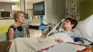 Patient in hospital bed with family member visiting