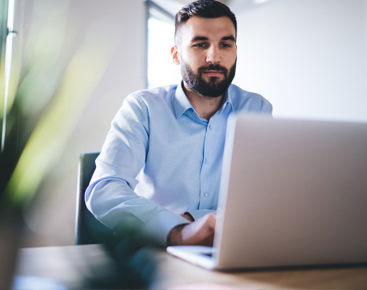 man typing at laptop