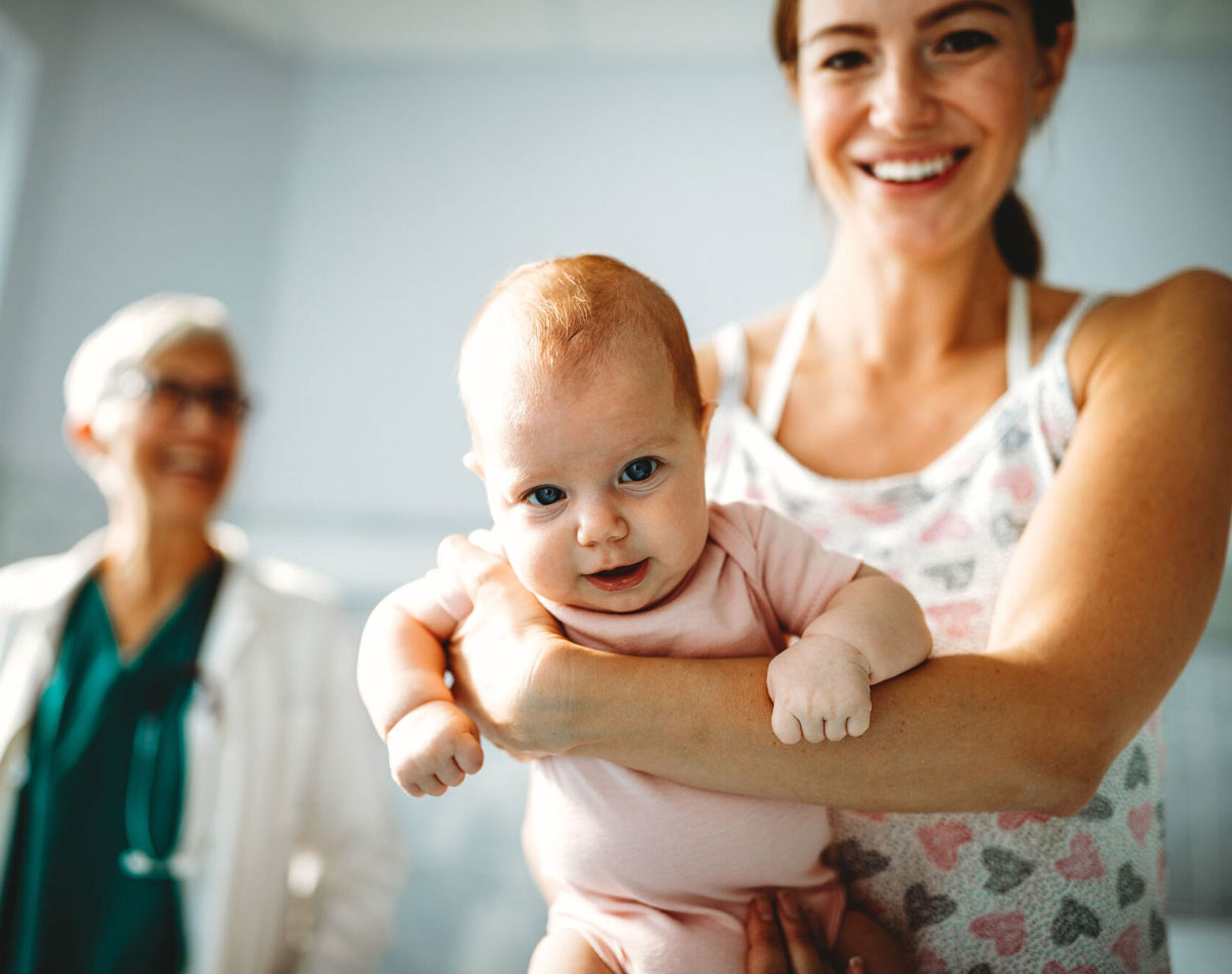 woman holding a smiling baby
